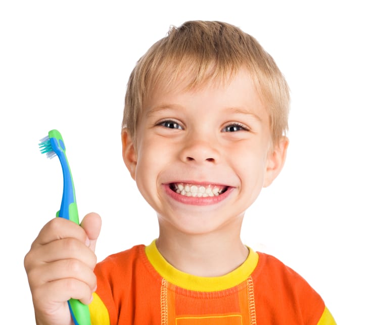 Boy smiling holding a toothbrush
